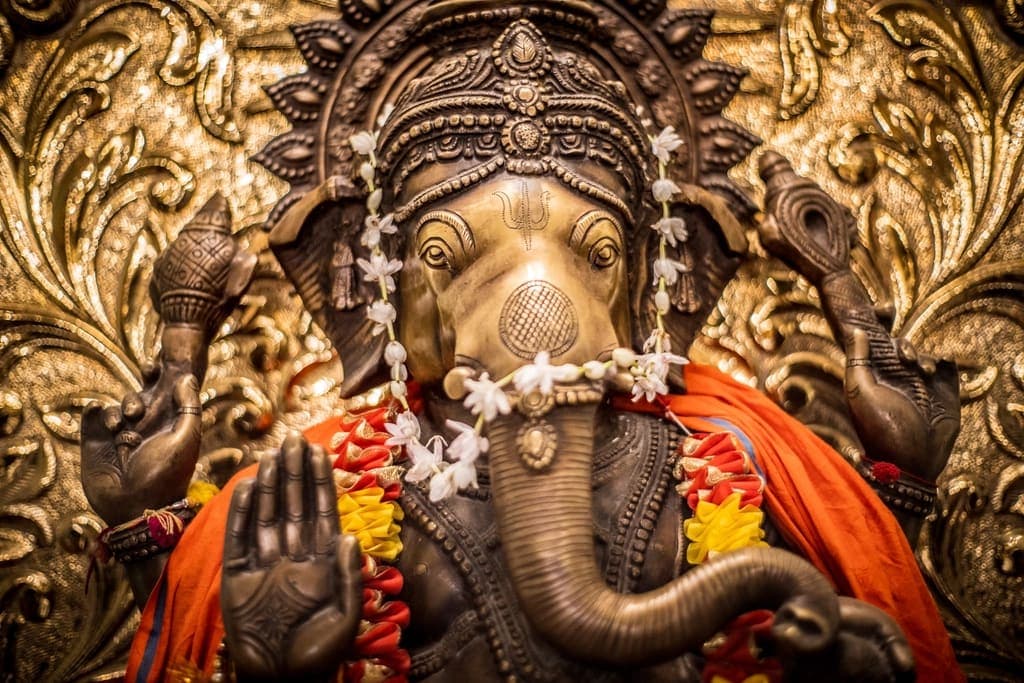 A Ganesha statue adorned with flowers